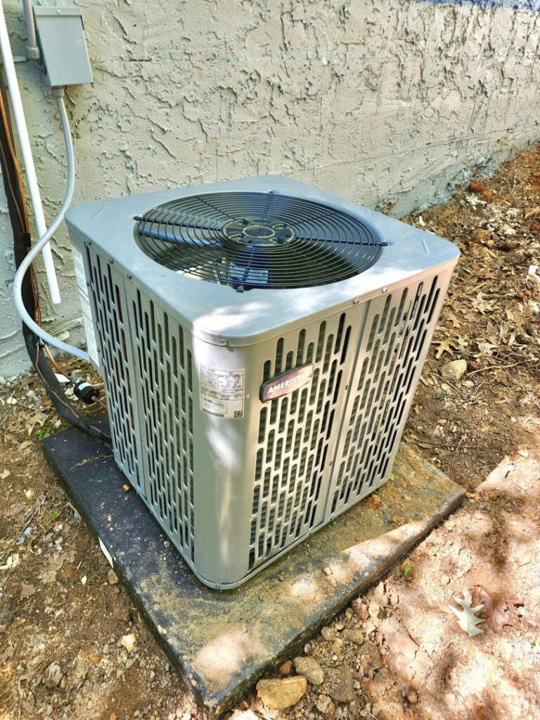 A standard outdoor HVAC condenser unit installed by Bruce Heating & Air in Kennewick, WA.