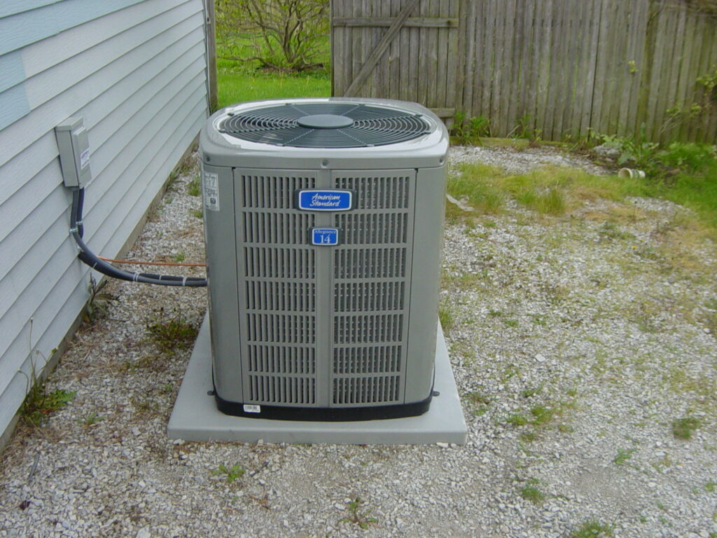 A newly installed or serviced outdoor HVAC condenser unit next to a home by F & S Williams in Lafayette, IN.