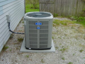 A newly installed or serviced outdoor HVAC condenser unit next to a home by F & S Williams in Lafayette, IN.