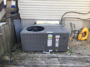 A newly installed outdoor HVAC condenser unit next to a residential building by Gouker's Best Air in Franklin, TN.
