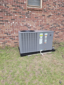 An outdoor HVAC condenser unit installed next to a brick house by GS Heating and Air LLC in West Columbia, SC