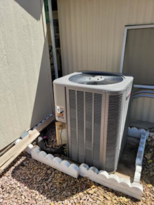 A newly installed Trane outdoor HVAC condenser unit next to a building by B3 Refrigeration LLC in Tempe, AZ