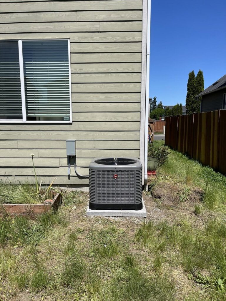 A newly installed outdoor HVAC condenser unit next to a residential home by Best Heat & Air in Tacoma, WA.