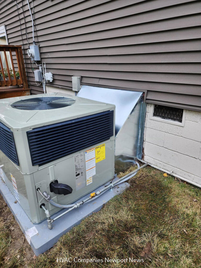 An outdoor HVAC condenser unit newly installed next to a residential building by Cannon Heating and Air Conditioning, LLC in Newport News, VA.