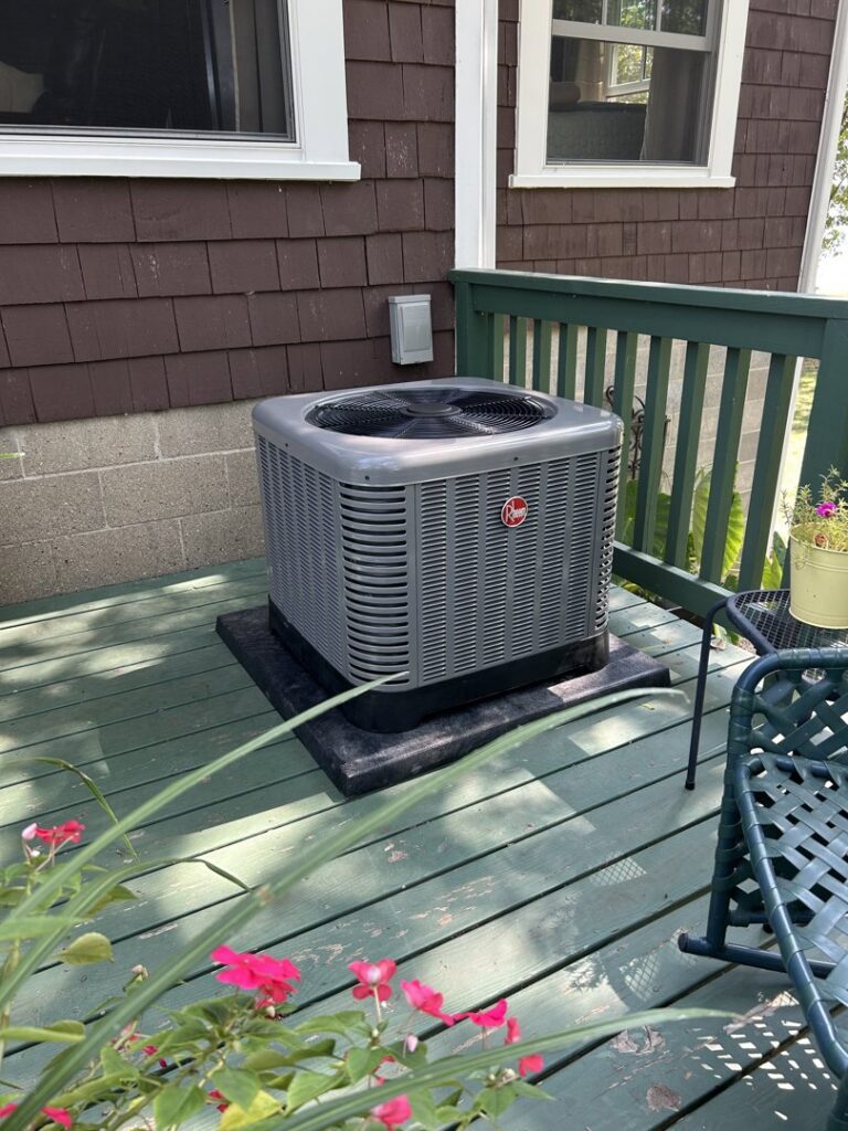 An outdoor HVAC condenser unit installed on a residential deck by Cool Tech Heating & Cooling in East Peoria, IL.