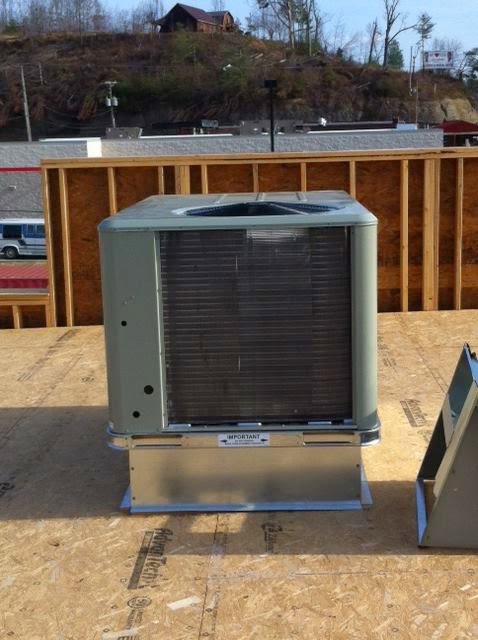 An outdoor HVAC condenser unit installed on a wooden platform, likely on a commercial rooftop by KATS Heating & Cooling in La Grange Park, IL.