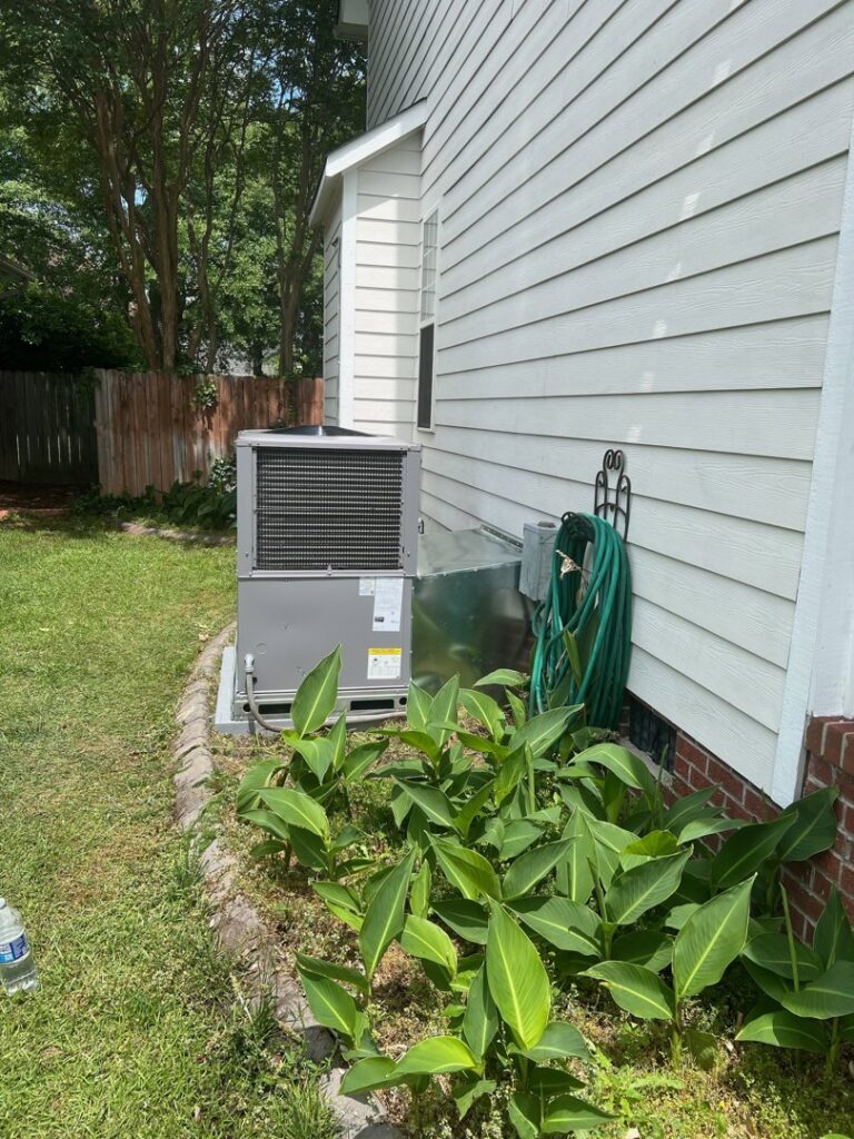 A well-maintained outdoor HVAC condenser unit installed by Southern Comfort Heating/Cooling/Gas in Fayetteville, NC.