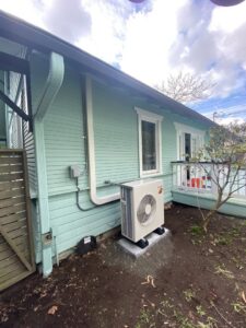 An outdoor heat pump unit installed on a residential property by Energy Technologies in Seattle, WA.