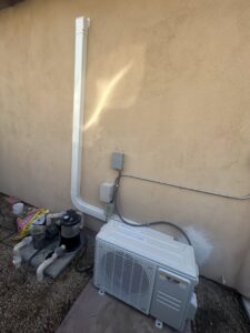 An outdoor HVAC heat pump or mini-split condenser unit installation by One Hour Heating & Air Conditioning of West Valley in Phoenix, AZ