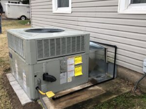 An outdoor HVAC package unit installation with gas line connection next to a residential home by Crouch's Heating & Cooling LLC in Stillwater, OK.