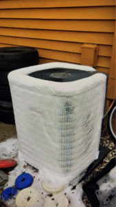 An outdoor HVAC unit covered in ice, ready for service by Seven 2 Seven Mechanical LLC in Concord, NC.