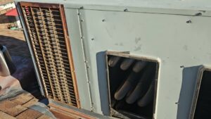 A close-up view of an outdoor HVAC unit's coils and components during an inspection by Alien Air Conditioning and Heating in Phoenix, AZ.