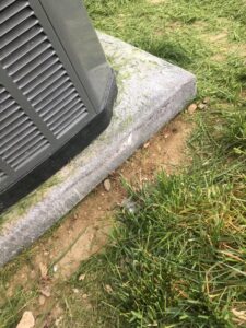 An outdoor HVAC unit on a concrete pad, showing a completed installation by Arrowhead Heating & Air Conditioning in Casper, WY.
