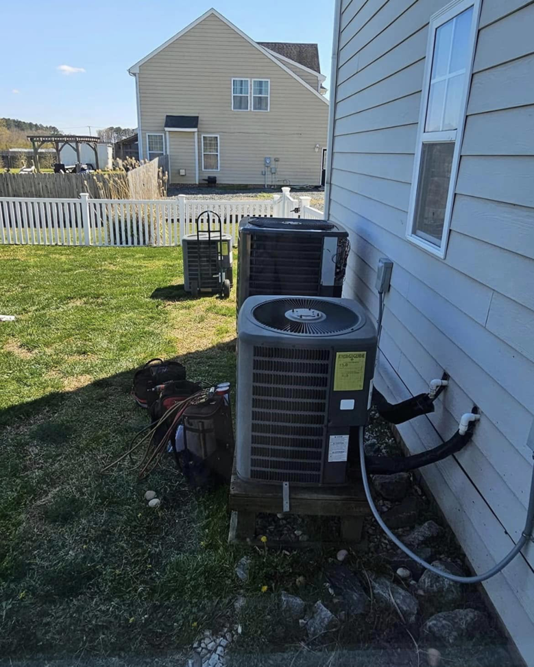 Outdoor HVAC unit installation with tools on the ground by Borte Mechanical Services LLC in Chesapeake, VA