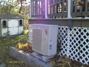 An outdoor HVAC unit installed next to a residential building by Trainor Mechanical in Nelson, BC