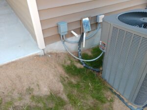 An outdoor HVAC unit with neatly installed lineset and electrical connections by NAS Heating & Air in Fayetteville, NC.