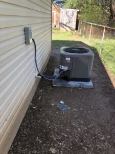 An outdoor HVAC unit installed next to a residential house by A&A HVAC and Electrical LLC in Nashville, TN.