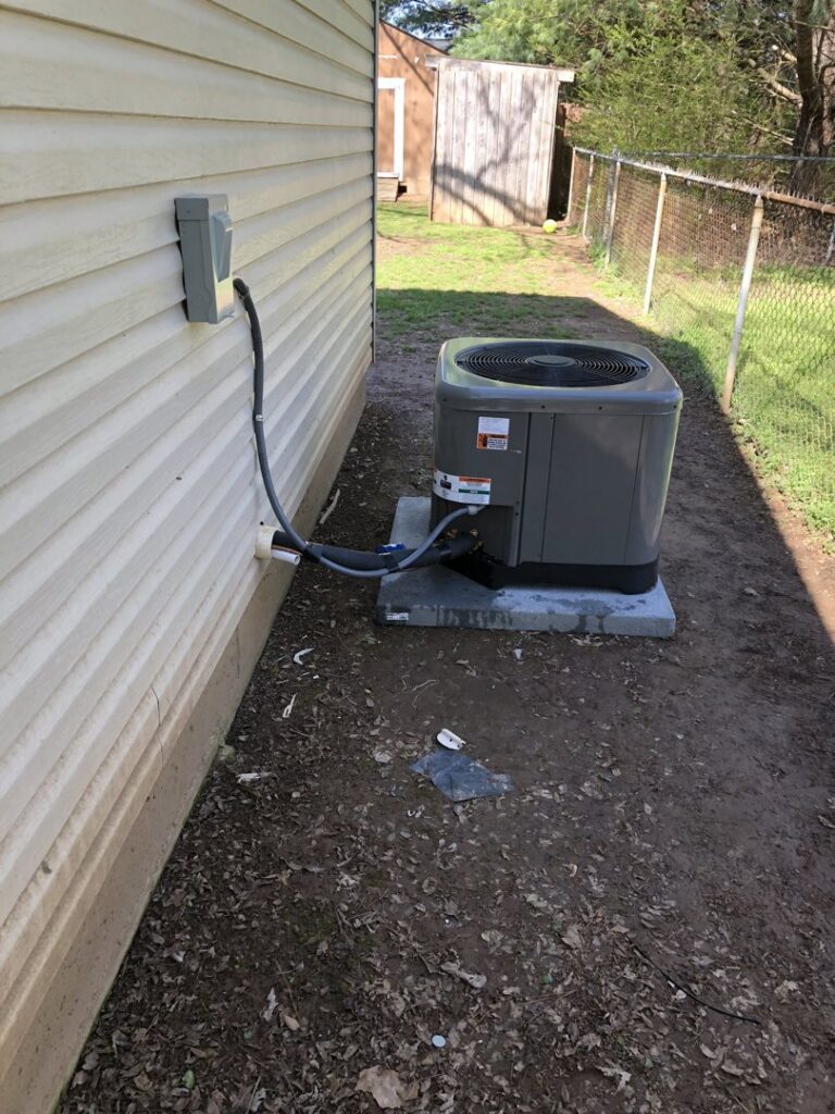 An outdoor HVAC unit installed next to a residential house by A&A HVAC and Electrical LLC in Nashville, TN.