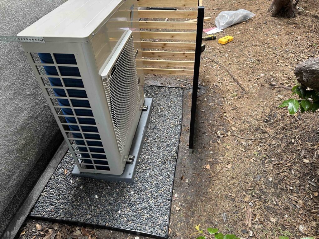 An outdoor HVAC unit installed on a decorative gravel bed by Air Comfort Experts in Pasadena, CA.
