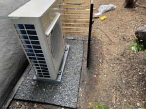 An outdoor HVAC unit installed on a decorative gravel bed by Air Comfort Experts in Pasadena, CA.