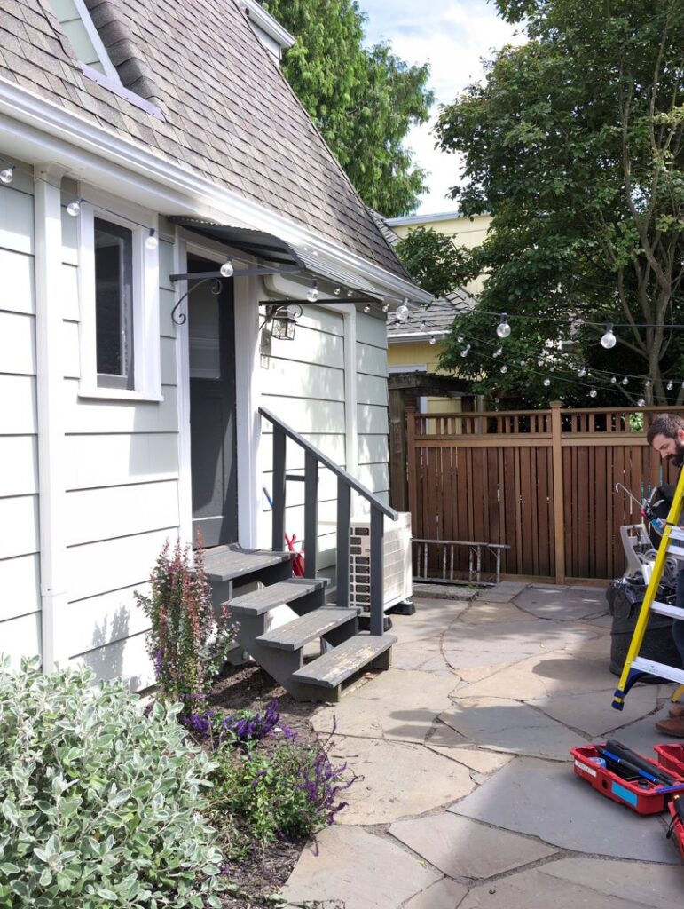 An outdoor HVAC unit installed next to a residential home by Progressive Comfort Solutions in Seattle, WA.