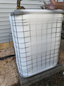 An outdoor HVAC unit protected with a winter cover, maintained by ECA DuctWorks in Reston, VA