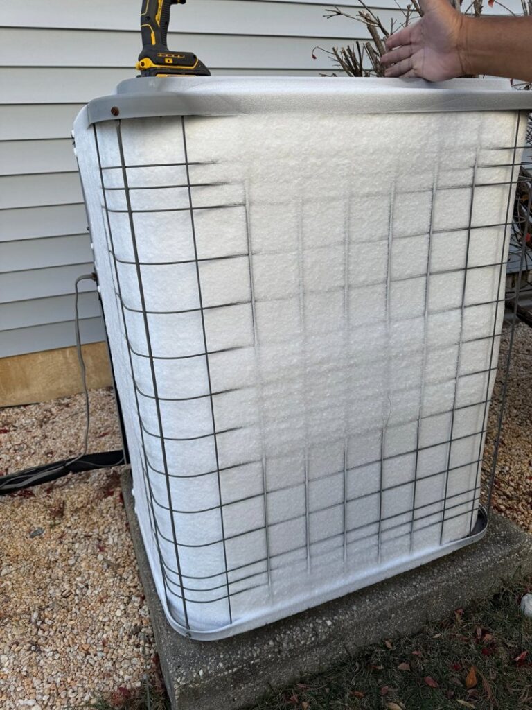 An outdoor HVAC unit protected with a winter cover, maintained by ECA DuctWorks in Reston, VA