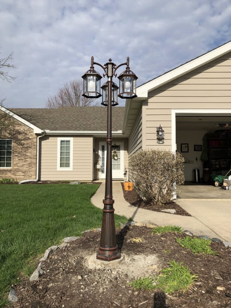 An installed outdoor lamp post in front of a residential home by Sterling Electric in Fort Wayne, IN.