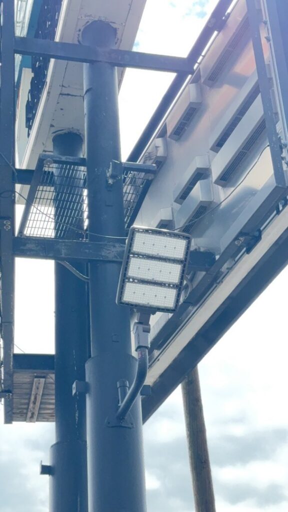 An outdoor LED floodlight mounted on a pole, installed by AC-DC Electric for commercial lighting in Severance, CO.