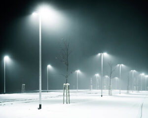 Bright outdoor LED street lighting illuminating a snowy area, installed by LMS Energy in Milwaukee, WI.