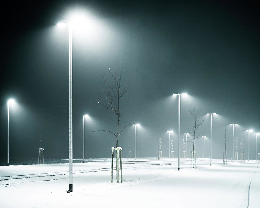 Bright outdoor LED street lighting illuminating a snowy area, installed by LMS Energy in Milwaukee, WI.