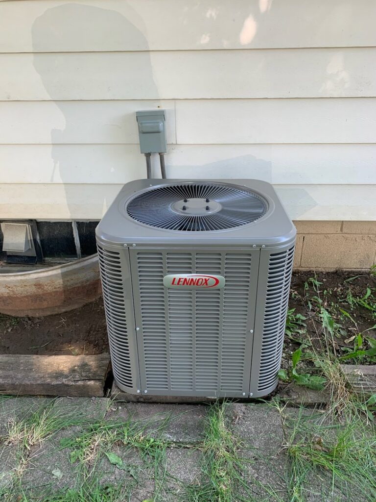 An outdoor Lennox air conditioning unit installed by Heating and Cooling Drs of Waukesha, Pewaukee, and Delafield, Waukesha, WI.