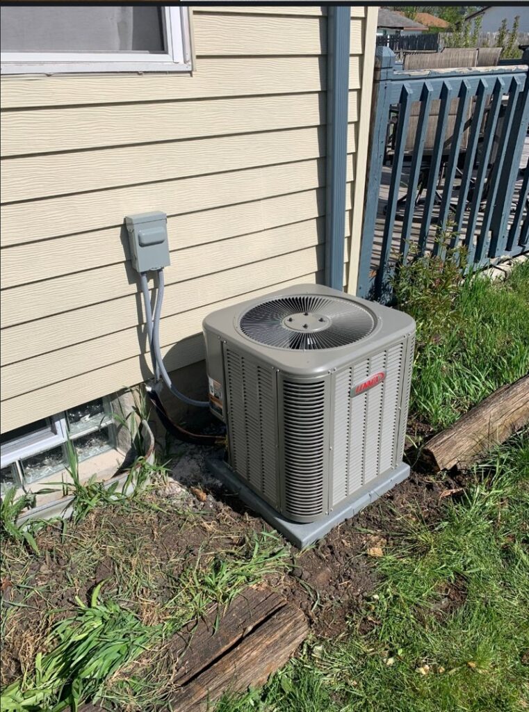 An outdoor Lennox air conditioning unit installed next to a residential house by Heating and Cooling Drs of Waukesha, Pewaukee, and Delafield, Waukesha, WI.