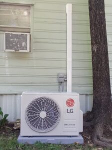 An outdoor LG mini-split condenser unit installed next to a house by TAG Heat N Air in North Little Rock, AR.
