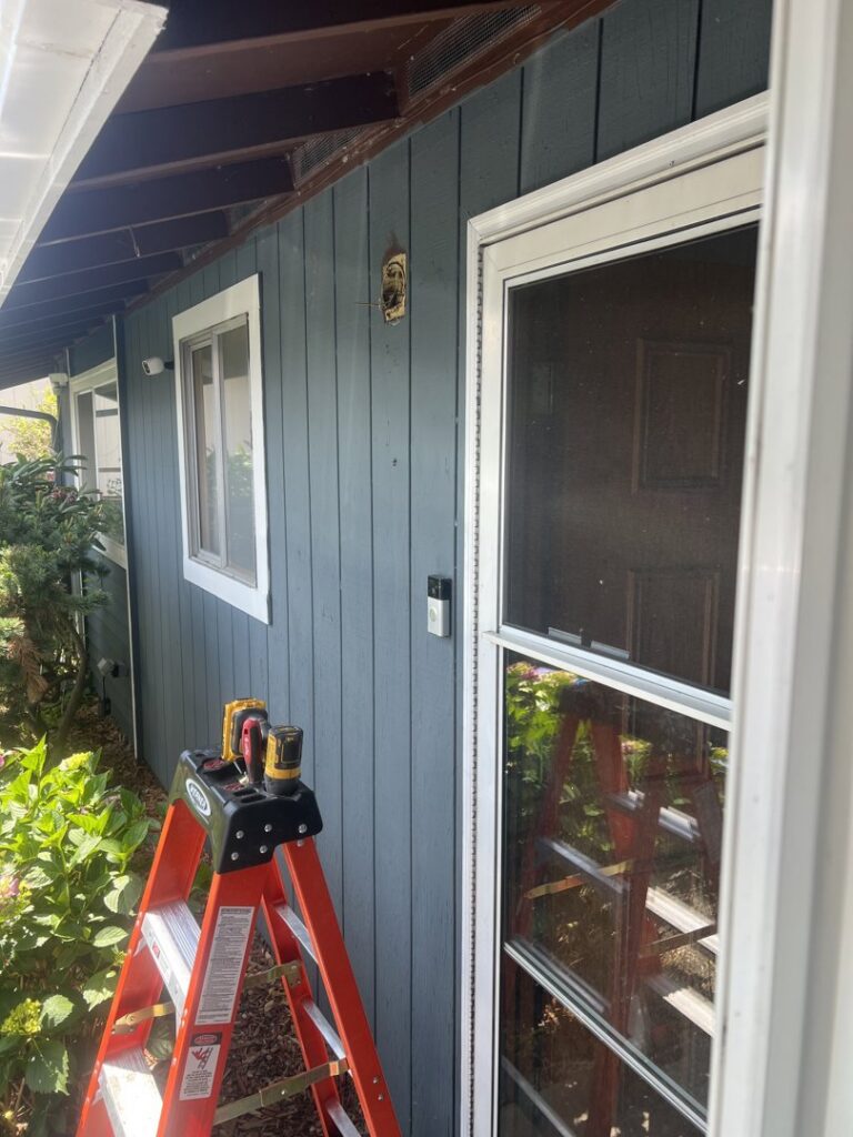 Outdoor wall showing old light fixture removed and new doorbell installed, ready for new lighting by Andrew's Electric in Kent, WA