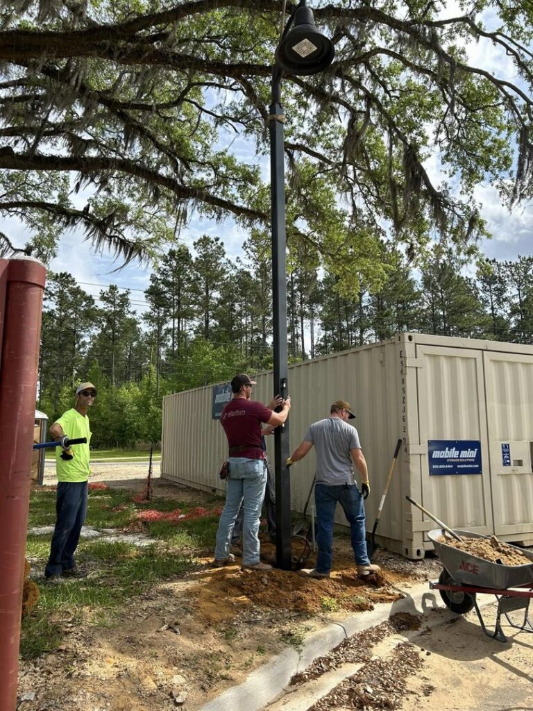 Albritton Electrical Service, Inc. team installing a new outdoor light pole in Tallahassee, FL.