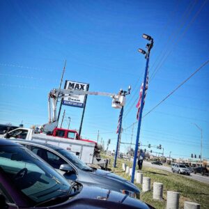 Lumenus Technologies, LLC performing outdoor lighting maintenance at a car dealership in Lenexa, KS.
