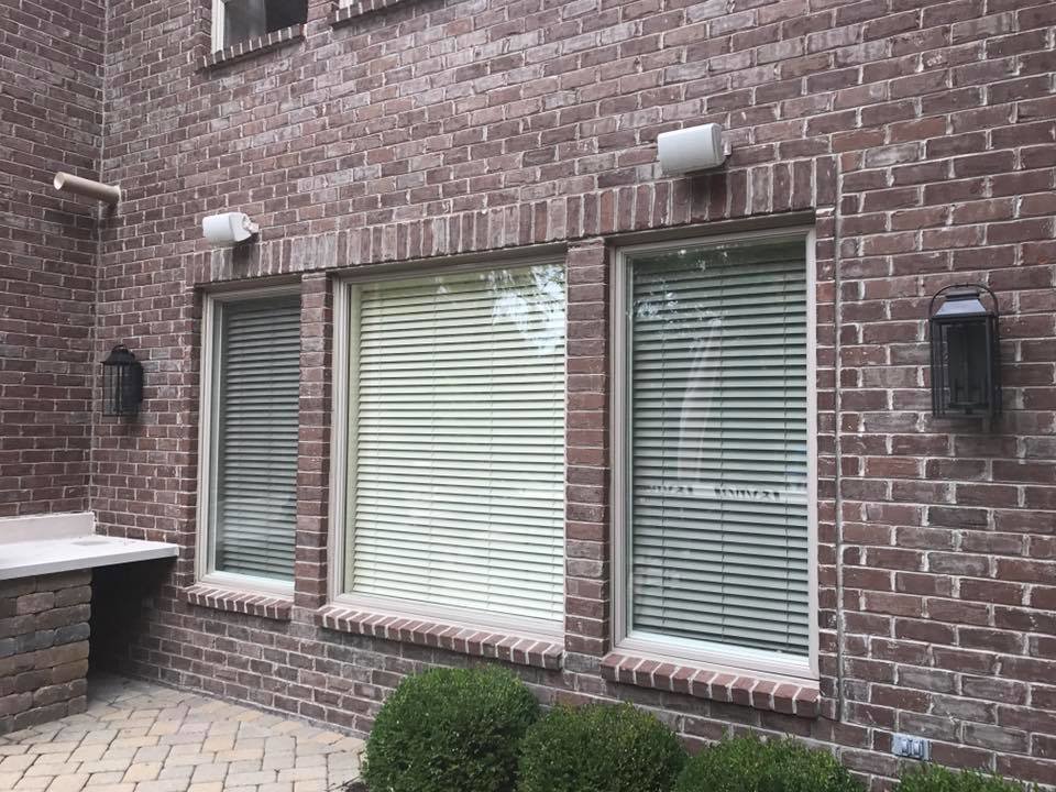 Outdoor wall lanterns and speakers installed on a home exterior by TGR Electric LLC in Carmel, IN.