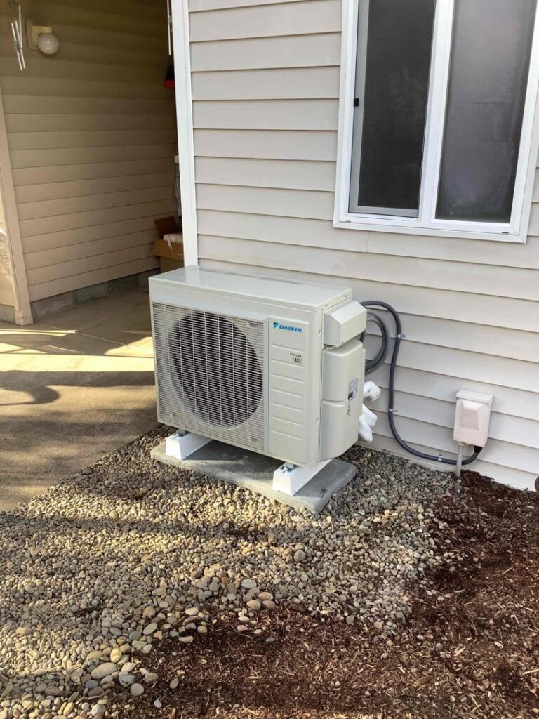 A newly installed Daikin mini-split AC outdoor unit by Alpine Heating in Eugene, OR.