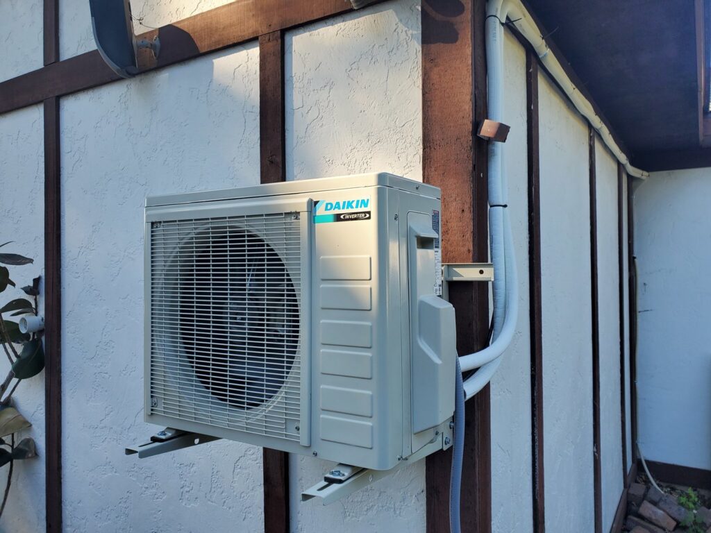 An outdoor mini-split AC unit installation by AccuMax Incorporated on a residential property in Aurora, IL.
