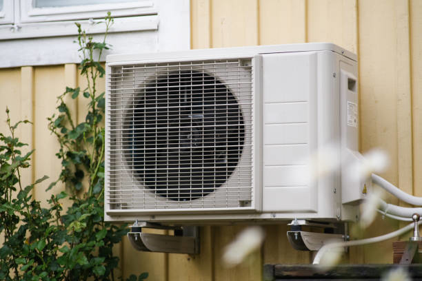 An outdoor mini-split air conditioning unit installed on a residential wall by Terry Allen Plumbing & Heating in Flint, MI.