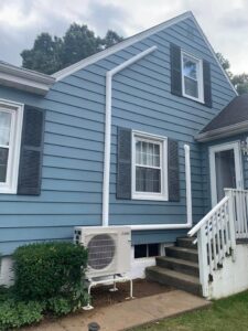 An outdoor mini-split condenser unit and line set installed by Call The Bee Plumbing, Heating, Air & Electric in Farmington, CT.