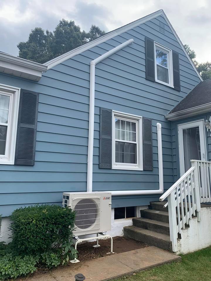 An outdoor mini-split condenser unit and line set installed by Call The Bee Plumbing, Heating, Air & Electric in Farmington, CT.