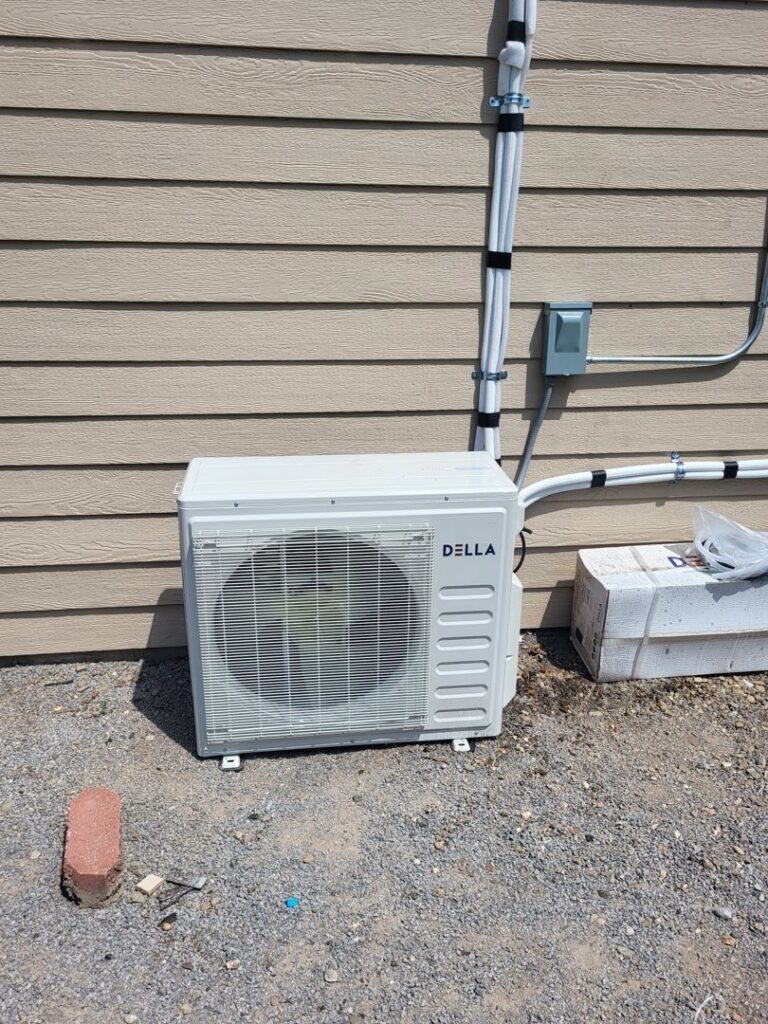 An outdoor mini-split condenser unit installed with piping by Chapman HVAC in Cleveland, OK.