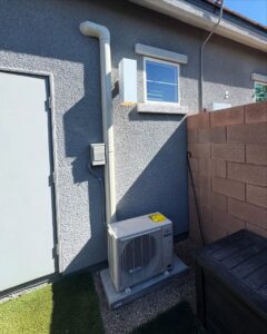 An outdoor mini-split condenser unit installed next to a building by Cool Camel HVAC in Henderson, NV