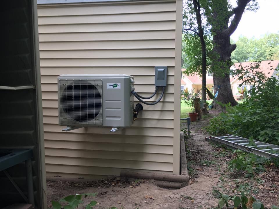 An outdoor mini-split condenser unit installed on the side of a building by Cool Tech Heating & Cooling in East Peoria, IL.