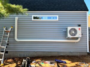 Outdoor mini-split condenser unit installation in progress by Fayette Plumbing & HVAC in Lexington, KY.