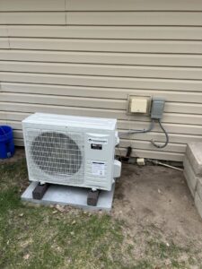 An outdoor mini-split condenser unit professionally installed by Millard Heating & Cooling in Elkhorn, NE.