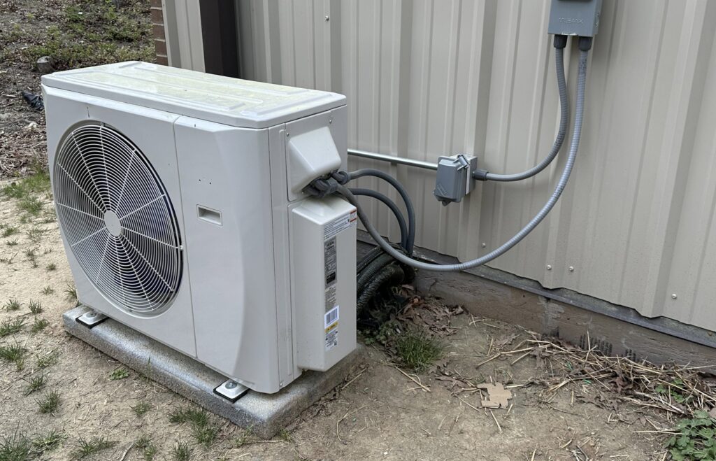 An outdoor mini-split condenser unit professionally installed by Lee Air Conditioning in Lafayette, LA.