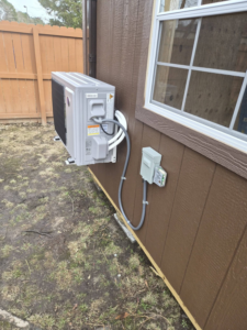 An outdoor mini-split condenser unit with electrical and refrigerant lines installed by Jesse's HVAC LLC in Newport News, VA.